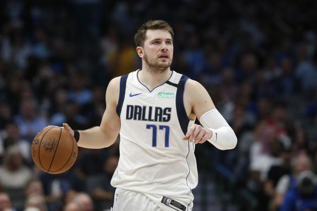 FILE - In this March 11, 2020, file photo, Dallas Mavericks guard Luka Doncic (77) handles the ball against the Denver Nuggets during the second half of an NBA basketball game in Dallas. Video games have become a go-to hobby for millions self-isolating around the world, and athletes from preps to pros have eagerly grabbed the controls. Stars like Ben Simmons and Luka Doncic have turned to gaming to stay connected with fans.(AP Photo/Ron Jenkins, File)