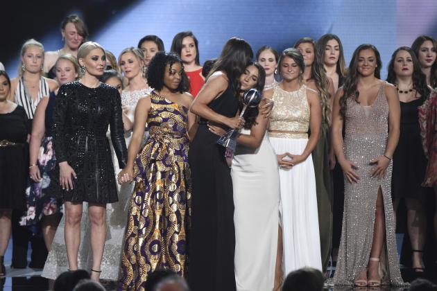 Jennifer Garner, front, embraces gymnast Aly Raisman after presenting the Arthur Ashe Award for Courage, at the ESPY Awards at Microsoft Theater on Wednesday, July 18, 2018, in Los Angeles. Holding hands in front left are former gymnast Sarah Klein and former Michigan State softball player Tiffany Thomas Lopez. More than 140 survivors of sexual abuse by a former team doctor for USA Gymnastics and Michigan State University joined hands on stage to be honored with the award. (Photo by Phil McCarten/Invision/AP)