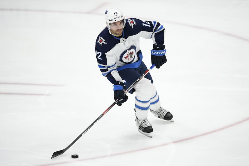 Winnipeg Jets defenseman Dylan DeMelo (12) skates with the puck during the third period of an NHL hockey game against the Washington Capitals, Tuesday, Feb. 25, 2020, in Washington. The Capitals won 4-3 in shootout. (AP Photo/Nick Wass)