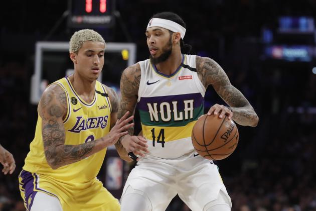New Orleans Pelicans' Brandon Ingram (14) dribbles next to Los Angeles Lakers' Kyle Kuzma during the second half of an NBA basketball game Tuesday, Feb. 25, 2020, in Los Angeles. (AP Photo/Marcio Jose Sanchez)