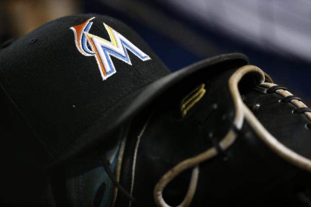 A Miami Marlins hat sits atop a baseball glove against the Washington Nationals, Sunday, July 29, 2018, in Miami. (AP Photo/Brynn Anderson)