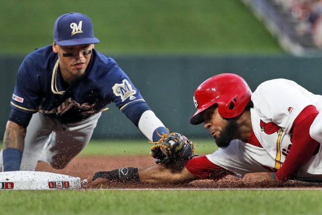 St. Louis Cardinals' Jose Martinez, right, is tagged out at third by Milwaukee Brewers shortstop Orlando Arcia during the second inning of a baseball game Monday, April 22, 2019, in St. Louis. (AP Photo/Jeff Roberson)
