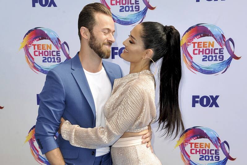 Artem Chigvintsev, left, and Nikki Bella arrive at the Teen Choice Awards on Sunday, Aug. 11, 2019, in Hermosa Beach, Calif. (Photo by Richard Shotwell/Invision/AP)