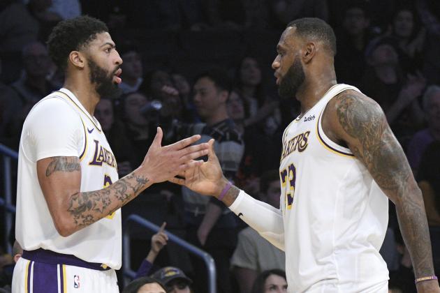 Los Angeles Lakers forward Anthony Davis, left, slaps hands with guard LeBron James during an NBA basketball game against the Dallas Mavericks Sunday, Dec. 29, 2019, in Los Angeles. (AP Photo/Michael Owen Baker)
