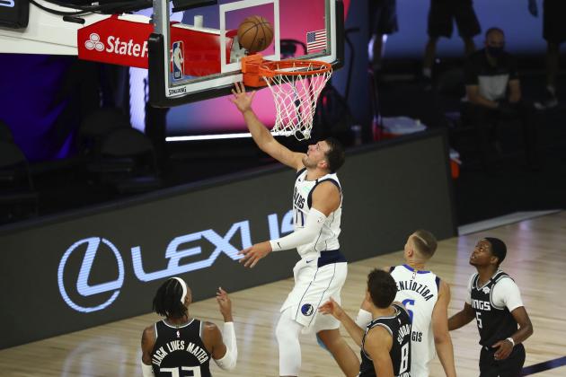 Dallas Mavericks guard Luka Doncic (77) shoots against the Sacramento Kings in the second half of an NBA basketball game Tuesday, Aug. 4, 2020, in Lake Buena Vista, Fla. (Kim Klement/Pool Photo via AP)