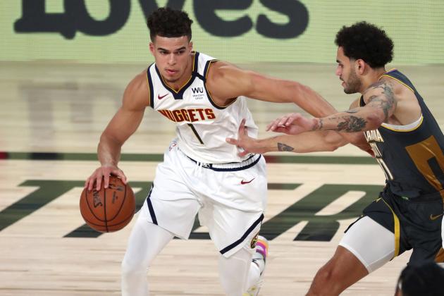 Denver Nuggets forward Michael Porter Jr. (1) dribbles the ball against Oklahoma City Thunder forward Abdel Nader (11) during an NBA basketball game Monday, Aug. 3, 2020, in Lake Buena Vista, Fla. (Kim Klement/Pool Photo via AP)