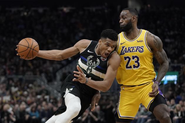 Milwaukee Bucks' Giannis Antetokounmpo tries to drive past Los Angeles Lakers' LeBron James during the second half of an NBA basketball game Thursday, Dec. 19, 2019, in Milwaukee. The Bucks won 111-104. (AP Photo/Morry Gash)