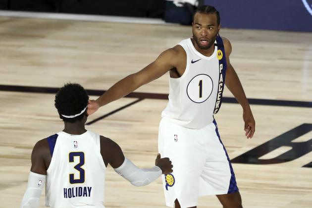 Indiana Pacers forward T.J. Warren (1) celebrates with guard Aaron Holiday (3) during the fourth quarter of an NBA basketball game against the Los Angeles Lakers, Saturday, Aug. 8, 2020, in Lake Buena Vista, Fla. (Kim Klement/Pool Photo via AP)