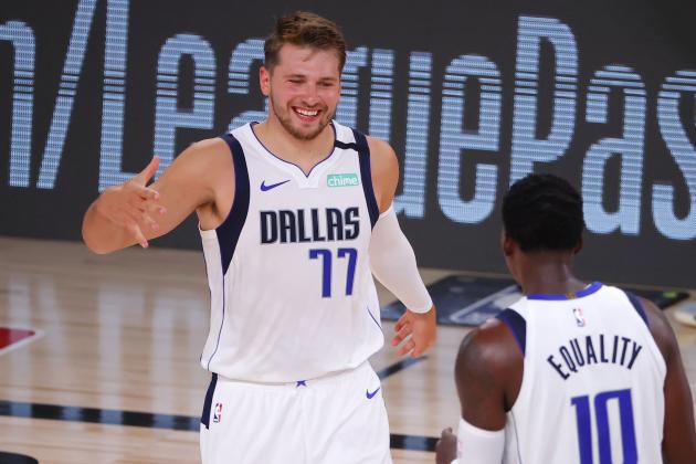 Dallas Mavericks' Luka Doncic (77) celebrates a three point-basket with teammate Dorian Finney-Smith (10) during the fourth quarter of an NBA basketball game against the Milwaukee Bucks, Saturday, Aug. 8, 2020, in Lake Buena Vista, Fla. (Kevin C. Cox/Pool Photo via AP)