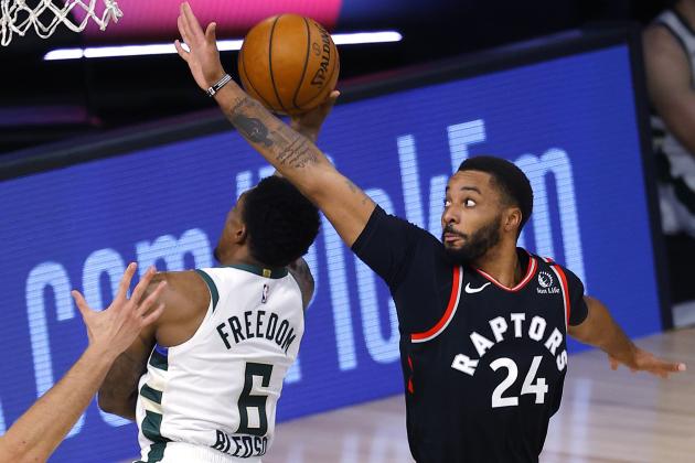 Toronto Raptors' Norman Powell, right, defends against Milwaukee Bucks' Eric Bledsoe during the third quarter of an NBA basketball game Monday, Aug. 10, 2020, in Lake Buena Vista, Fla. (Mike Ehrmann/Pool Photo via AP)