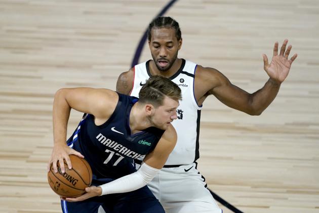 Los Angeles Clippers' Kawhi Leonard, right, applies pressure on Dallas Mavericks' Luka Doncic (77) during the second half of an NBA basketball game Thursday, Aug. 6, 2020 in Lake Buena Vista, Fla. (AP Photo/Ashley Landis, Pool)
