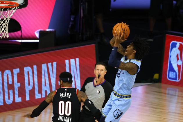 Memphis Grizzlies' Ja Morant, right, goes up for a shot against the Portland Trail Blazers during the first half of an NBA basketball game Saturday, Aug. 15, 2020, in Lake Buena Vista, Fla. (Kevin C. Cox/Pool Photo via AP)