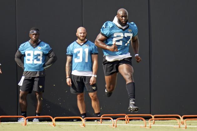 Jacksonville Jaguars running back Leonard Fournette (27) runs through a drill as wide receiver Marvelle Ross (83) and running back Nathan Cottrell (31) look on during an NFL football workout, Wednesday, Aug. 12, 2020, in Jacksonville, Fla. (AP Photo/John Raoux)