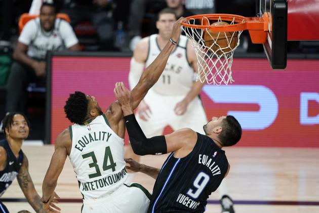 Milwaukee Bucks' Giannis Antetokounmpo (34) dunks the ball over Orlando Magic's Nikola Vucevic (9) during the second half of an NBA basketball first round playoff game Monday, Aug. 24, 2020, in Lake Buena Vista, Fla. (AP Photo/Ashley Landis, Pool)
