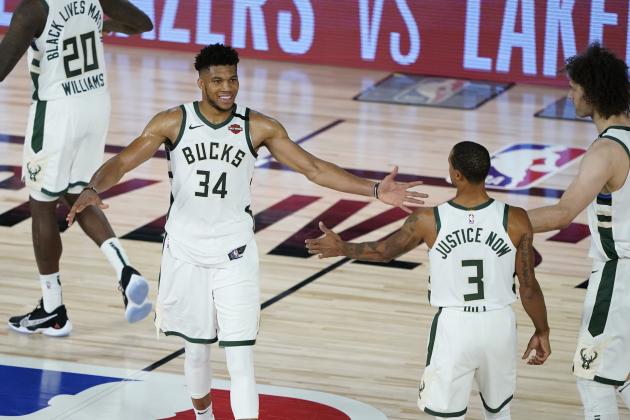 Milwaukee Bucks forward Giannis Antetokounmpo (34) celebrates the team's win over the Orlando Magic with guard George Hill (3) and center Robin Lopez (42) in an NBA basketball first round playoff game, Thursday, Aug. 20, 2020, in Lake Buena Vista, Fla. (AP Photo/Ashley Landis, Pool)
