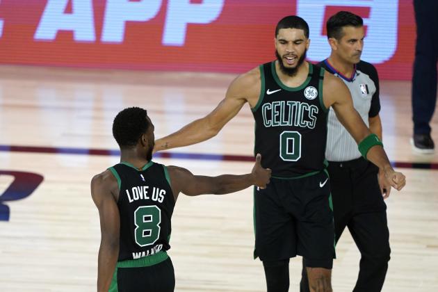Boston Celtics' Kemba Walker (8) and Jayson Tatum (0) celebrate during the first half of an NBA basketball first round playoff game against the Philadelphia 76ers Monday, Aug. 17, 2020, in Lake Buena Vista, Fla. (AP Photo/Ashley Landis, Pool)