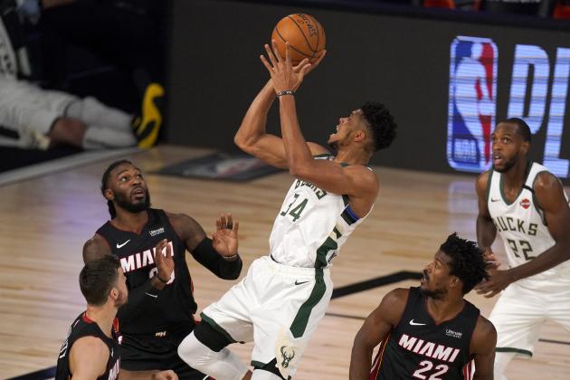 Miami Heat's Goran Dragic, bottom left, Jae Crowder, top left, and Jimmy Butler (22) defend as Milwaukee Bucks' Giannis Antetokounmpo (34) attempt to shoot during the first half of an NBA basketball conference semifinal playoff game, Monday, Aug. 31, 2020, in Lake Buena Vista, Fla. Bucks Khris Middleton, right rear, looks on. (AP Photo/Mark J. Terrill)