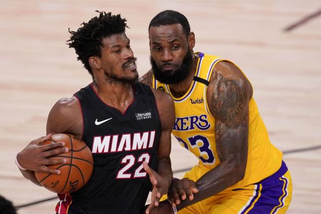 Miami Heat forward Jimmy Butler drives around Los Angeles Lakers forward LeBron James during the second half in Game 4 of basketball's NBA Finals Tuesday, Oct. 6, 2020, in Lake Buena Vista, Fla. (AP Photo/Mark J. Terrill)