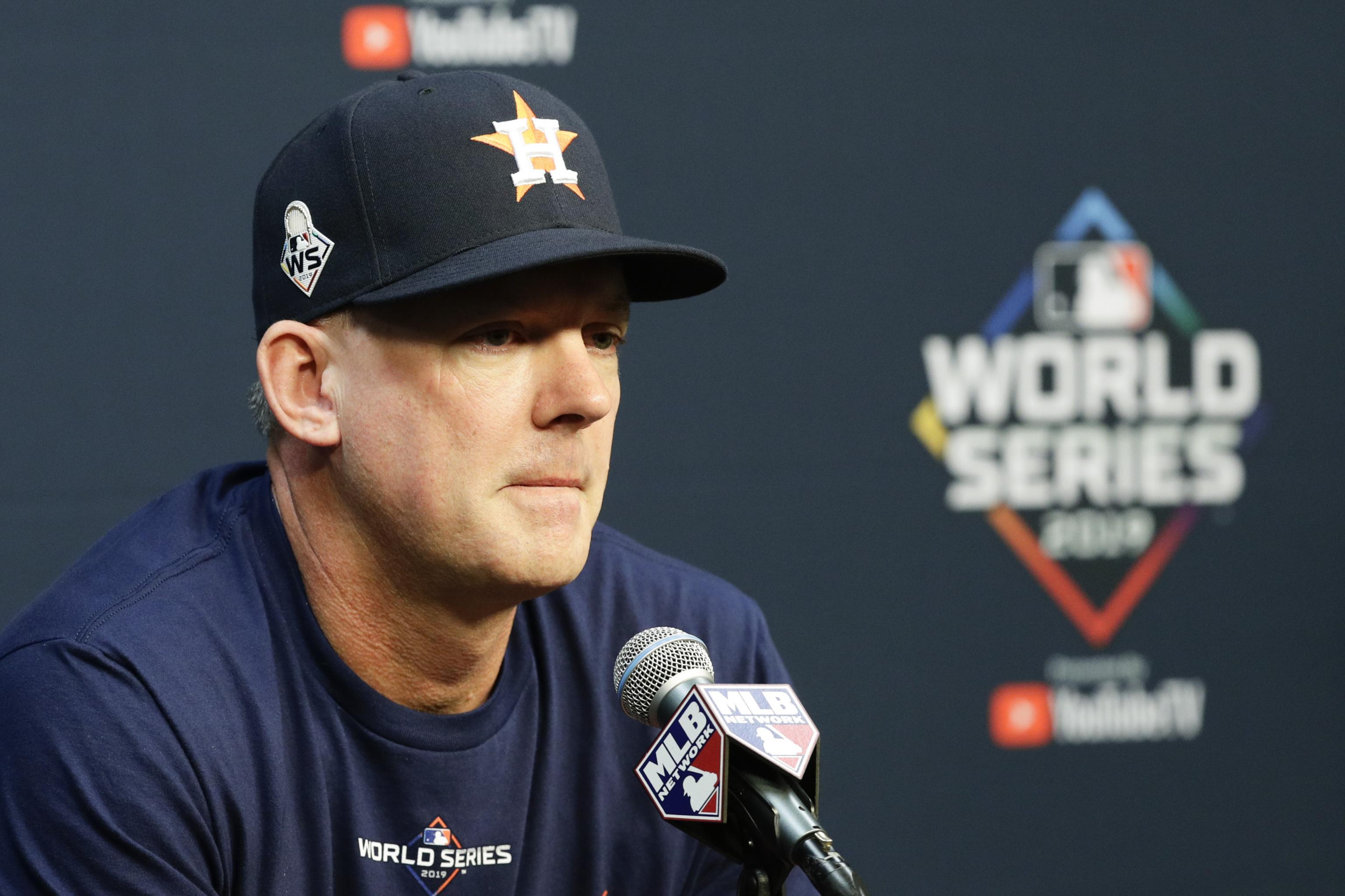 Manager AJ Hinch of the Houston Astros and family on the field