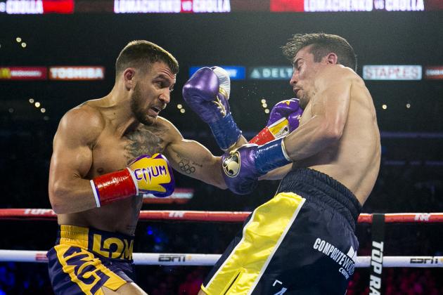 FILE - In this April 12, 2019, file photo, Vasiliy Lomachenko, left, from Ukraine, hits Anthony Crolla, from Britain, during a WBA and WBO lightweight title boxing match in Los Angeles. In ordinary times Vasiliy Lomachenko and Teofimo Lopez would be the fight of the fall, a lightweight title match about as compelling as it gets in the boxing world these days. Instead of a big crowd, the only fans at the MGM Grand conference center will be a few hundred sponsors and first responders with special invites. And, instead of pay-per-view, the fight will be televised live on ESPN, guaranteeing a larger audience than a pay-per-view even if the money isn’t nearly the same. (AP Photo/Damian Dovarganes, File)