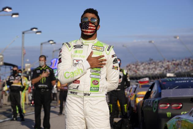 Bubba Wallace participates in the national anthem before a NASCAR Cup Series auto race Sunday, Sept. 6, 2020, in Darlington, S.C. (AP Photo/Chris Carlson)
