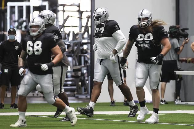 Las Vegas Raiders offensive tackle Trent Brown, center, warms up alongside offensive tackle Andre James (68) and guard Jordan Roos during an NFL football training camp practice Wednesday, Aug. 26, 2020, in Henderson, Nev. (Chase Stevens/Las Vegas Review-Journal via AP, Pool)
