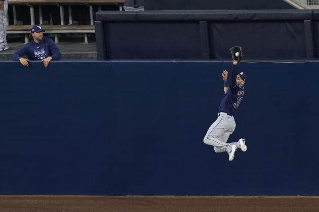 Tampa Bay Rays center fielder Kevin Kiermaier makes a leaping catch on a fly ball by Houston Astros Alex Bregman during the first inning in Game 3 of a baseball American League Championship Series, Tuesday, Oct. 13, 2020, in San Diego. (AP Photo/Gregory Bull)