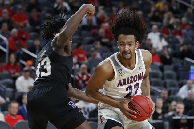 Arizona's Zeke Nnaji (22) drives into Washington's Isaiah Stewart (33) during the second half of an NCAA college basketball game in the first round of the Pac-12 men's tournament Wednesday, March 11, 2020, in Las Vegas. (AP Photo/John Locher)
