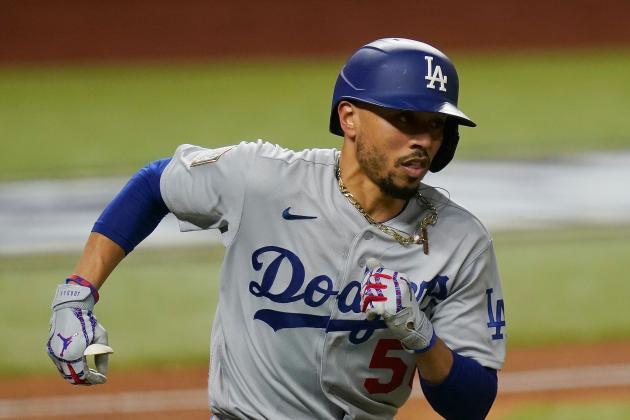 Los Angeles Dodgers' Mookie Betts runs to first after a RBI single against the Tampa Bay Rays during the fourth inning in Game 3 of the baseball World Series Friday, Oct. 23, 2020, in Arlington, Texas. (AP Photo/Eric Gay)