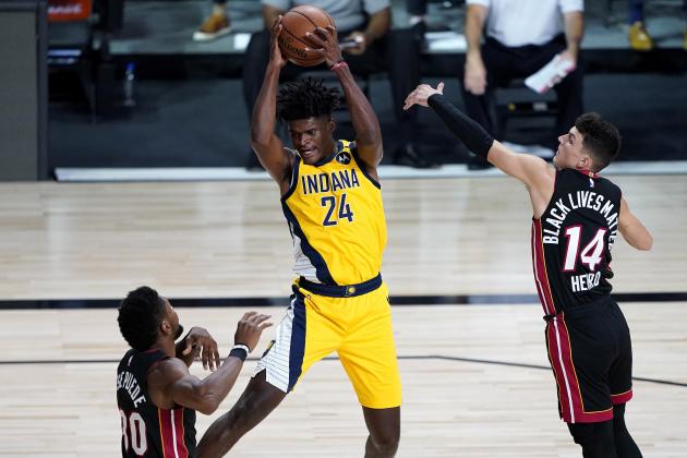 Indiana Pacers' Alize Johnson (24) pulls down a rebound as Miami Heat's Tyler Herro (14) and Chris Silva (30) defend during the first half of an NBA basketball game Monday, Aug. 3, 2020, in Lake Buena Vista, Fla. (AP Photo/Ashley Landis, Pool)