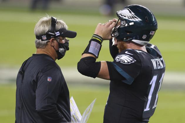 Philadelphia Eagles' head coach Doug Pederson talks with Carson Wentz (11) during a timeout against the New York Giants during an NFL football game, Thursday, Oct. 22, 2020, in Philadelphia. The Eagles defeated the Giants 22-21. (AP Photo/Rich Schultz)
