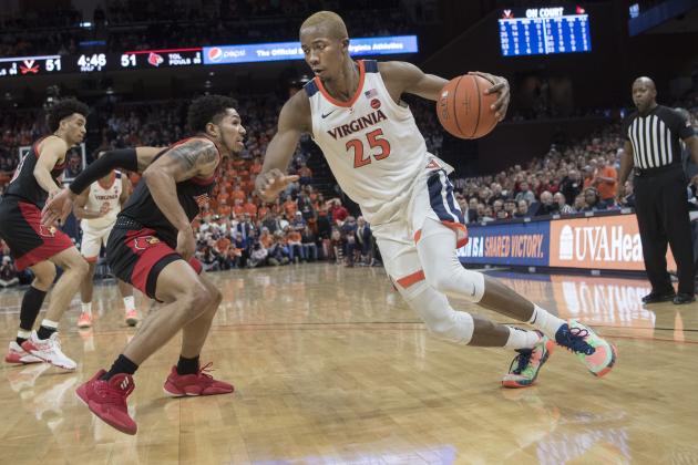 Virginia forward Mamadi Diakite (23) drives around Louisville defender Lamarr Kimble (0) during the second half of an NCAA college basketball game in Charlottesville, Va., Saturday, March 7, 2020. (AP Photo/Lee Luther Jr.)