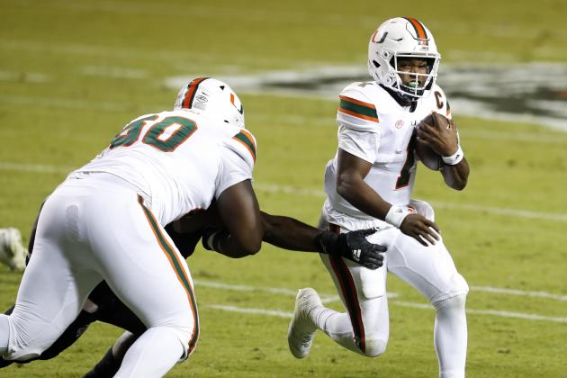Miami quarterback D'Eriq King (1) runs past North Carolina State linebacker Isaiah Moore, obscured at left, during the first half of an NCAA college football game Friday, Nov. 6, 2020, in Raleigh, N.C. (Ethan Hyman/The News & Observer via AP, Pool)