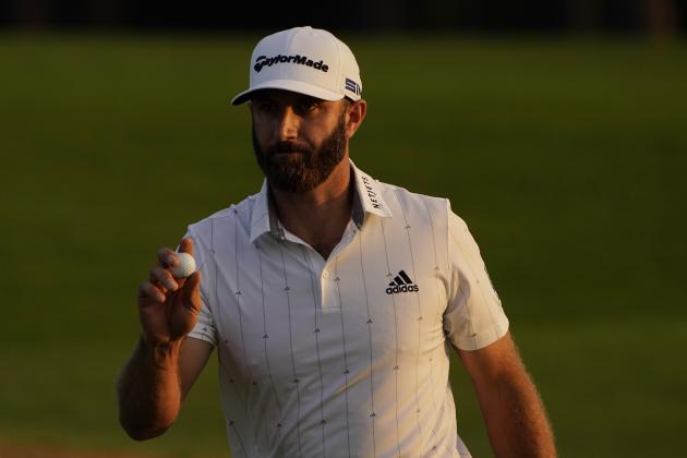 Dustin Johnson holds up his ball on the 18th green after his third round of the Masters golf tournament Saturday, Nov. 14, 2020, in Augusta, Ga. (AP Photo/Chris Carlson)