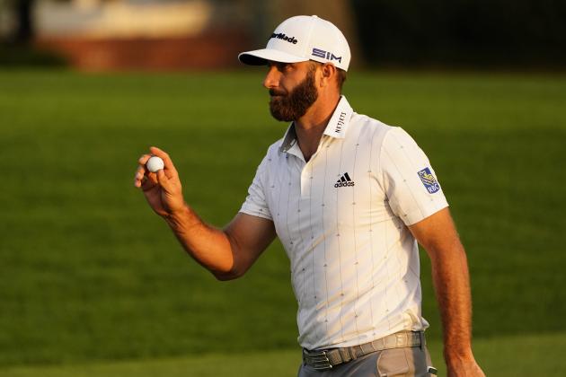 Dustin Johnson holds up his ball on the 18th green after his third round of the Masters golf tournament Saturday, Nov. 14, 2020, in Augusta, Ga. (AP Photo/Matt Slocum)