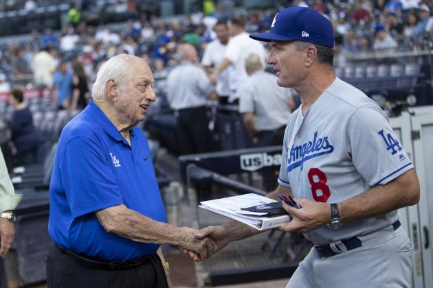 Former Los Angeles Dodgers manager Tommy Lasorda, left, talks with bench coach Bob Geren (8) before a baseball game against the San Diego Padres Tuesday, Aug. 27, 2019, in San Diego. (AP Photo/Gregory Bull)