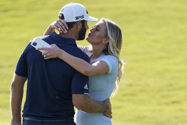 Dustin Johnson celebrates with his partner Paulina Gretzky on the 18th green after winning the Tour Championship golf tournament and FedEx Cup on Monday, Sept. 7, 2020 at East Lake Golf Club in Atlanta. (AP Photo/John Bazemore)