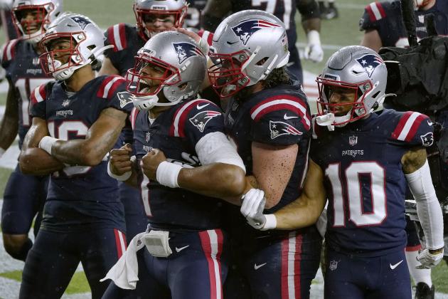 New England Patriots quarterback Cam Newton, center, celebrates his rushing touchdown with teammates in the second half of an NFL football game against the Baltimore Ravens, Sunday, Nov. 15, 2020, in Foxborough, Mass. (AP Photo/Charles Krupa)