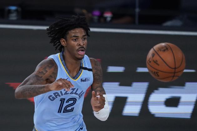 Memphis Grizzlies' Ja Morant (12) makes a pass during an NBA basketball game against San Antonio Spurs Sunday, Aug. 2, 2020, in Lake Buena Vista, Fla. (AP Photo/Ashley Landis, Pool)
