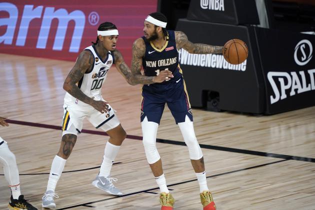 New Orleans Pelicans' Brandon Ingram, right, looks to pass around Utah Jazz's Jordan Clarkson (00) during the first half of an NBA basketball game Thursday, July 30, 2020, in Lake Buena Vista, Fla. (AP Photo/Ashley Landis, Pool)