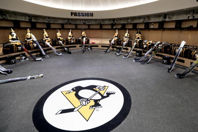 The team logo is in the center of the Pittsburgh Penguins locker room before players come in to talk to the media before leaving for the off season two days after being swept by the New York Islanders in the first round of the NHL hockey playoffs, Thursday, April 18, 2019, at their practice facility in Cranberry Township, Pa. (AP Photo/Keith Srakocic)