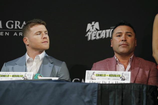 Canelo Alvarez, left, looks at promoter and former boxer Oscar de la Hoya during a news conference Wednesday, Oct. 30, 2019, in Las Vegas. Alvarez is scheduled to fight Sergey Kovalev in a WBO light heavyweight title bout Saturday in Las Vegas. (AP Photo/John Locher)