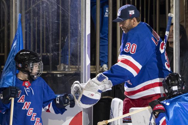 New York Rangers goaltender Henrik Lundqvist high fives a child as he arrives on the ice before the start of an NHL hockey game against the St. Louis Blues, Tuesday, March 3, 2020, at Madison Square Garden in New York. (AP Photo/Mary Altaffer)