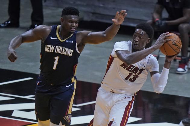 Miami Heat forward Bam Adebayo (13) looks for a teammate past New Orleans Pelicans forward Zion Williamson (1) during the first half of a preseason NBA basketball game, Monday, Dec. 14, 2020, in Miami. (AP Photo/Wilfredo Lee)