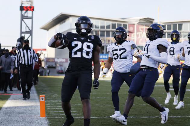 Iowa State running back Breece Hall, left, runs in a touchdown as West Virginia defensive lineman Jalen Thornton, center, and cornerback Nicktroy Fortune, right, are late to the play during the first half of an NCAA college football game, Saturday, Dec. 5, 2020, in Ames, Iowa. (AP Photo/Matthew Putney)