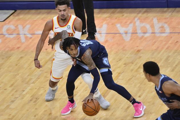 Memphis Grizzlies guard Ja Morant (12) handles the ball against Atlanta Hawks guard Trae Young in the first half of an NBA basketball game Saturday, Dec. 26, 2020, in Memphis, Tenn. (AP Photo/Brandon Dill)