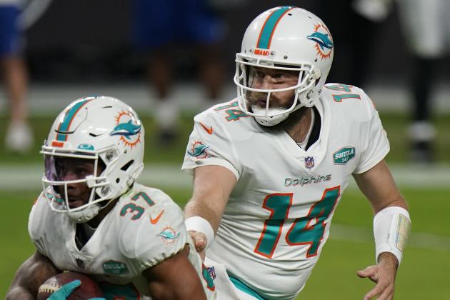 Miami Dolphins quarterback Ryan Fitzpatrick #14 hands off to running back Myles Gaskin #37 during the fourth quarter against the Las Vegas Raiders in an NFL football game, Saturday, Dec. 26, 2020, in Las Vegas. (AP Photo/Jeff Bottari)