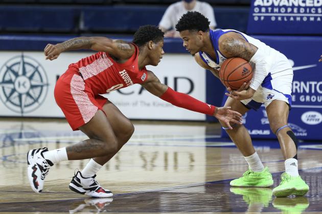 Tulsa's Elijah Joiner is guarded by Houston's Marcus Sasser during the first half of an NCAA college basketball game in Tulsa, Okla., Tuesday, Dec. 29, 2020. (AP Photo/Dave Crenshaw)