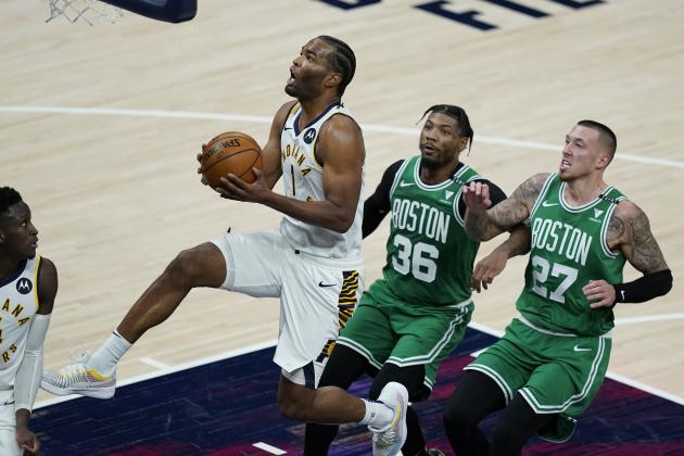 Indiana Pacers' T.J. Warren (1) goes to the basket as Boston Celtics' Marcus Smart (36) and Daniel Theis (27) trail during the second half of an NBA basketball game Tuesday, Dec. 29, 2020, in Indianapolis. (AP Photo/Darron Cummings)
