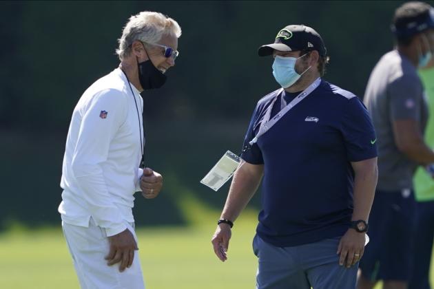 Seattle Seahawks head coach Pete Carroll, left, talks with general manager John Schneider during NFL football training camp, Friday, Aug. 14, 2020, in Renton, Wash. (AP Photo/Ted S. Warren)